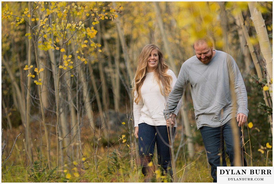 colorado mountain engagement session walking in the aspen trees