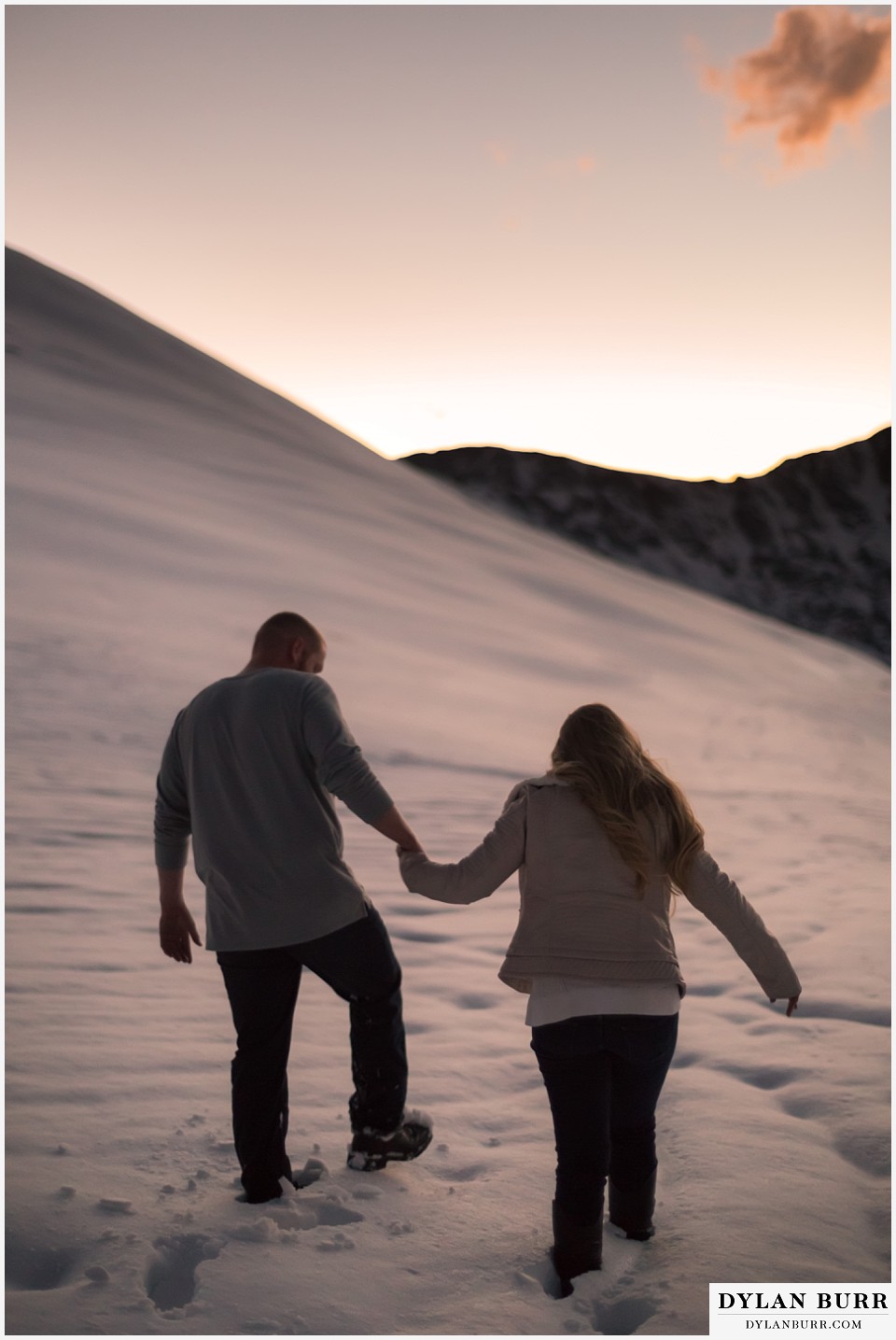 colorado mountain engagement session walking holding hands in deep mountain snow
