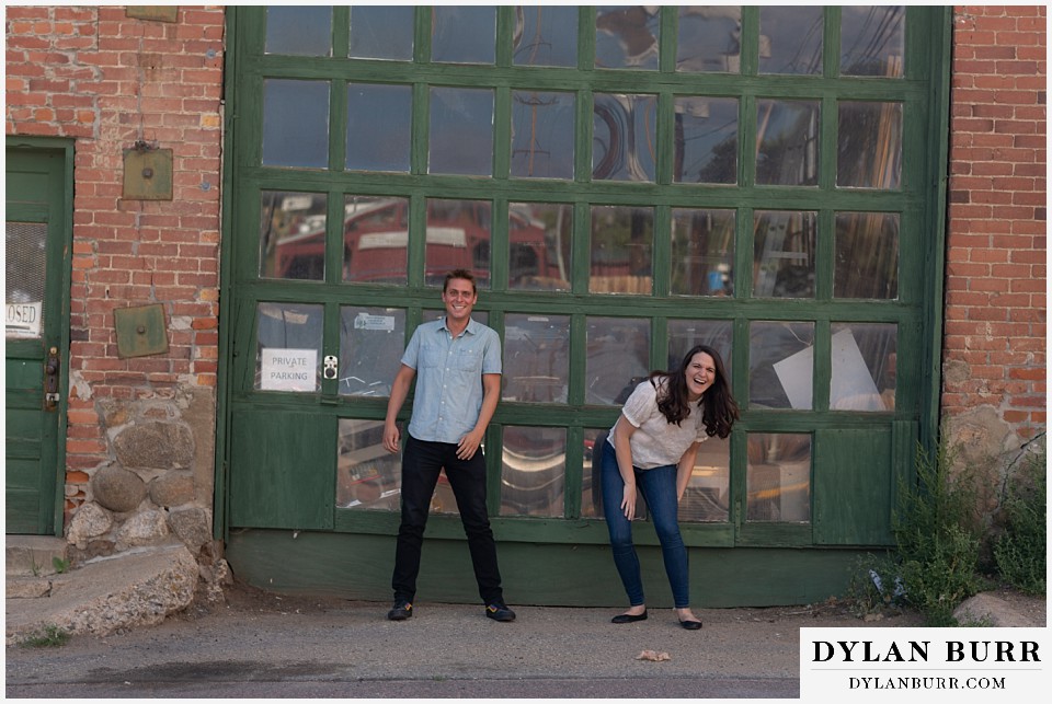colorado mountain engagement photos colorado wedding photographer dylan burr couple in front of antique store laughing