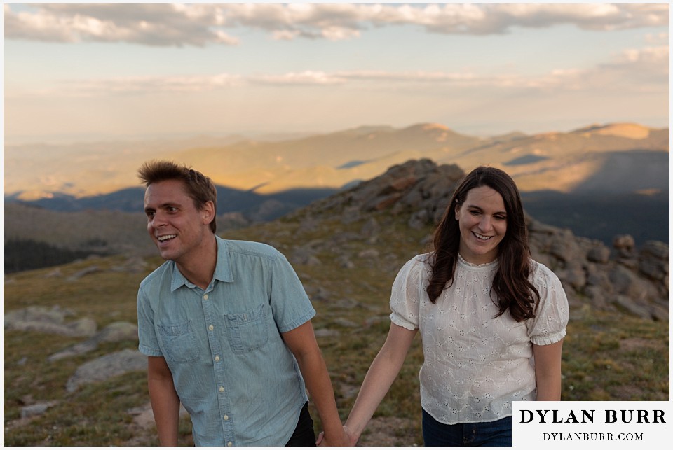 colorado mountain engagement photos colorado wedding photographer dylan burr couple holding hands laughing together