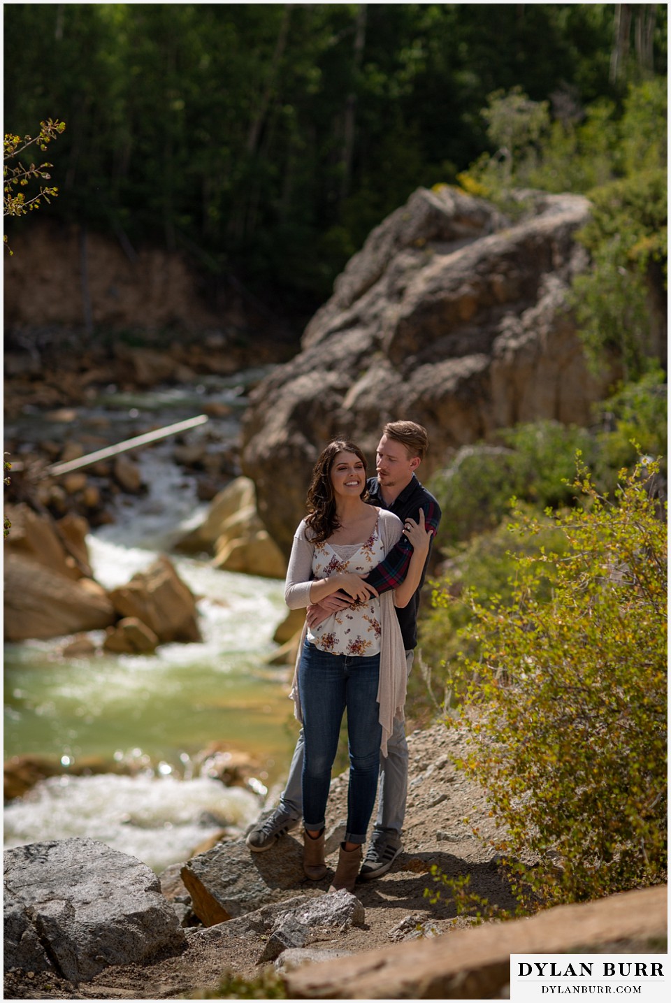 colorado mountain enagagement photos couple standing at lookout view of river