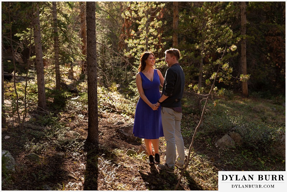 colorado mountain enagagement photos couple together in pine forest looking with lots of love