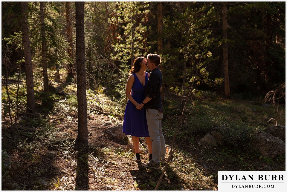 colorado mountain enagagement photos couple kissing in pine tree forest