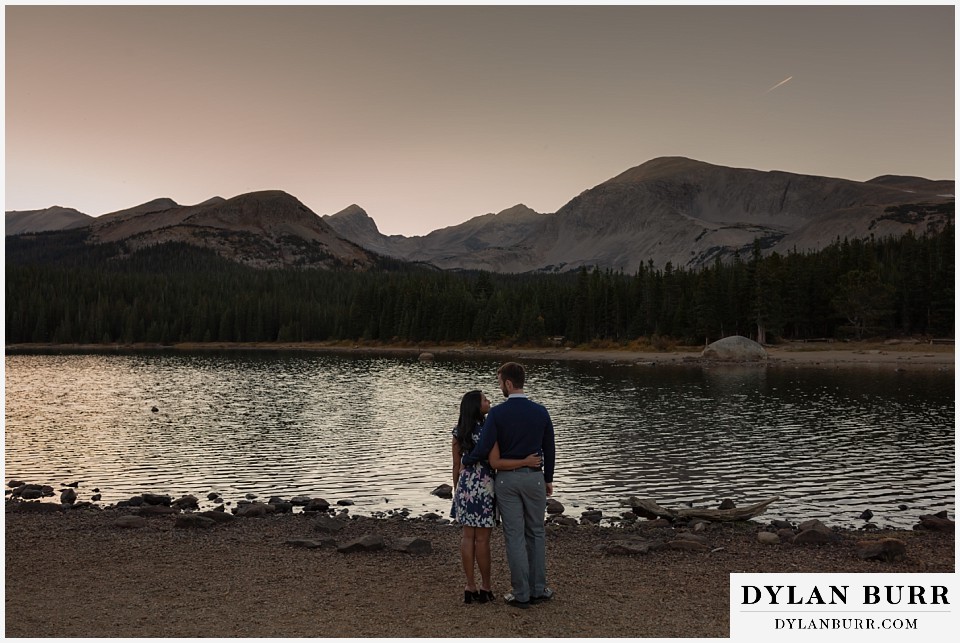 colorado engagement photos in mountains watching the sunset at the lake