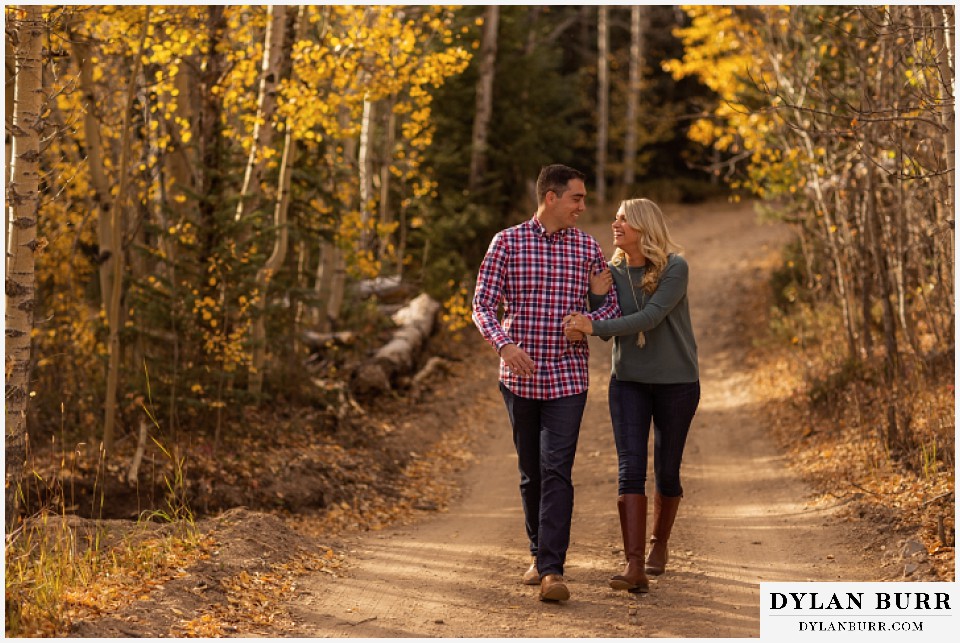 colorado mountain engagement session laughing hand in hand