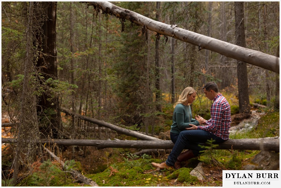 colorado mountain engagement session couple in woods talking