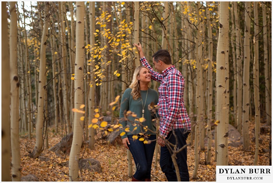 colorado mountain engagement session couple in aspen trees in fall