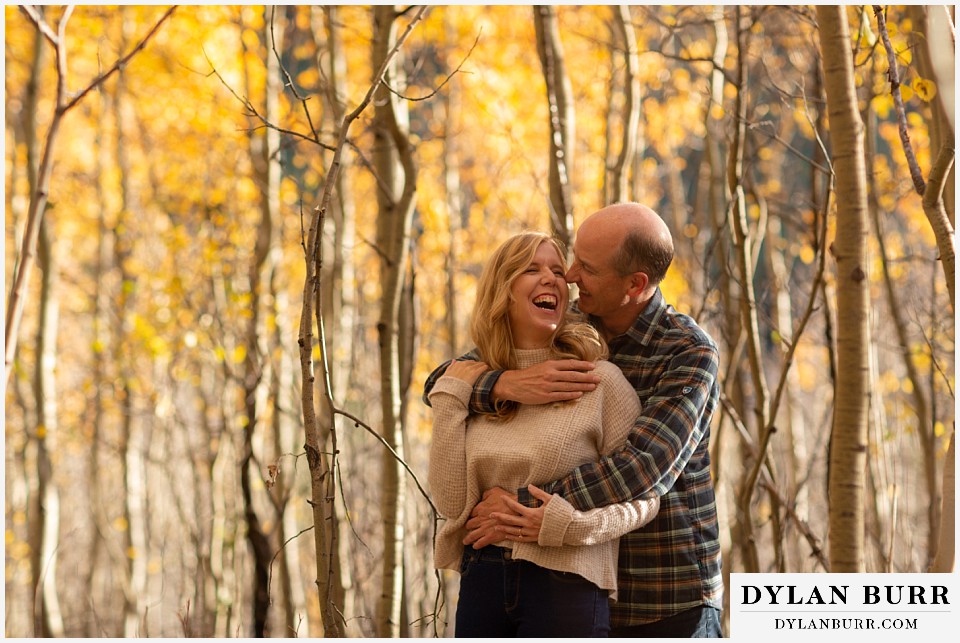 colorado engagement session in mountains couple laughing in trees