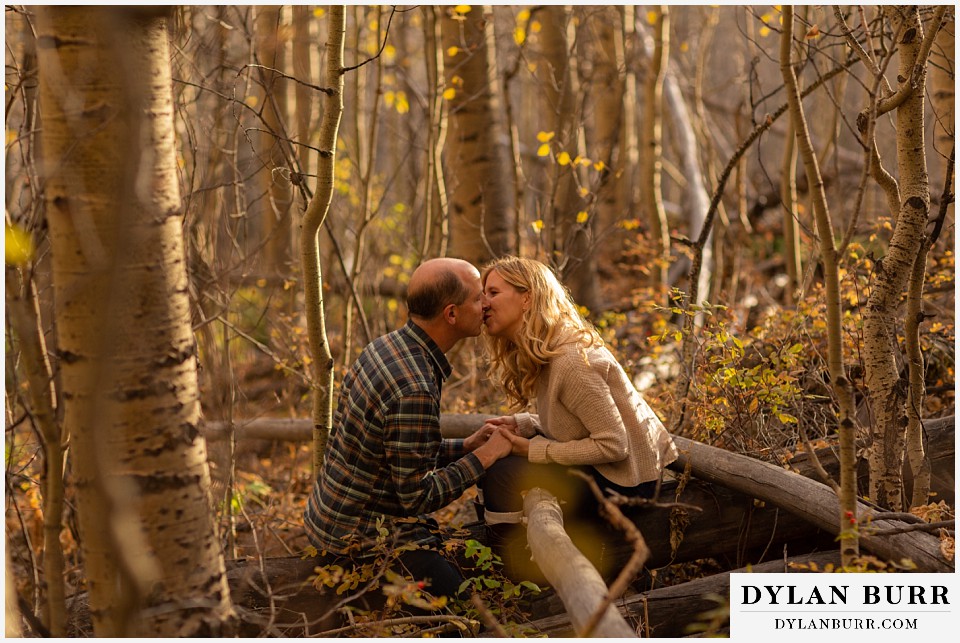 colorado engagement session in mountains couple kissing in forest