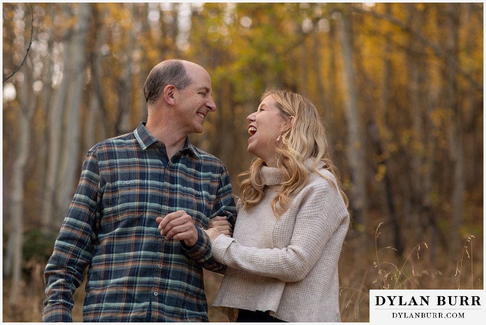 colorado engagement session in mountains couple laughing in autumn weather
