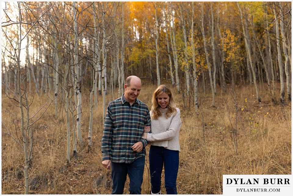 colorado engagement session in mountains walking out of the trees together