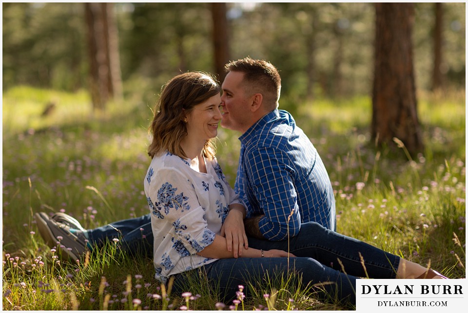 golden colorado mountain enagagement photo session couple sitting in grass together