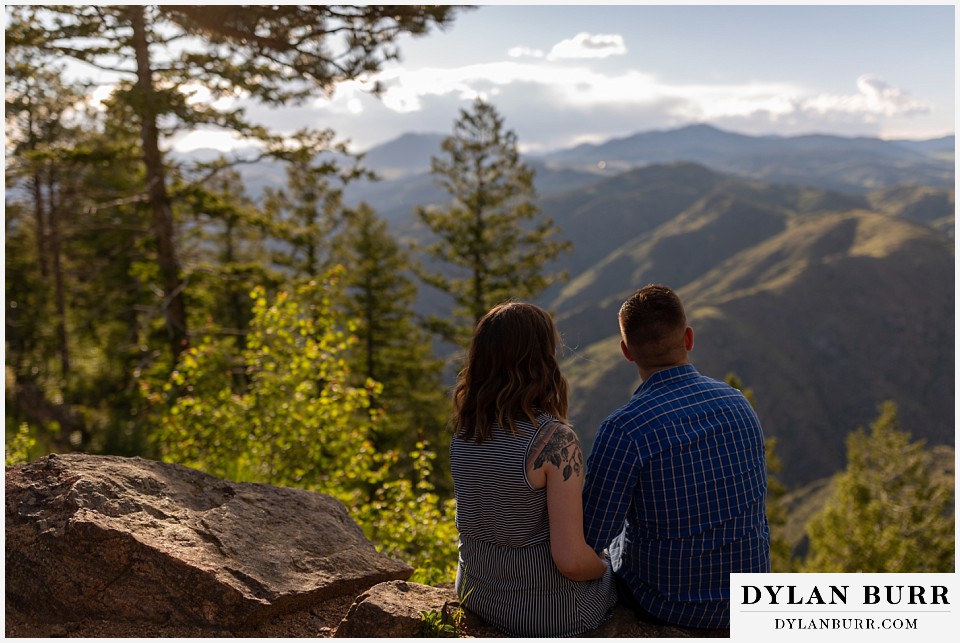 golden colorado mountain enagagement photo session couple looking out at the mountains together