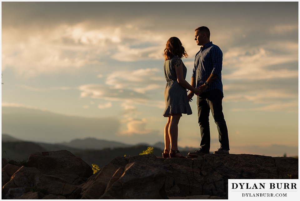golden colorado mountain enagagement photo session couple on mountain top at sunset
