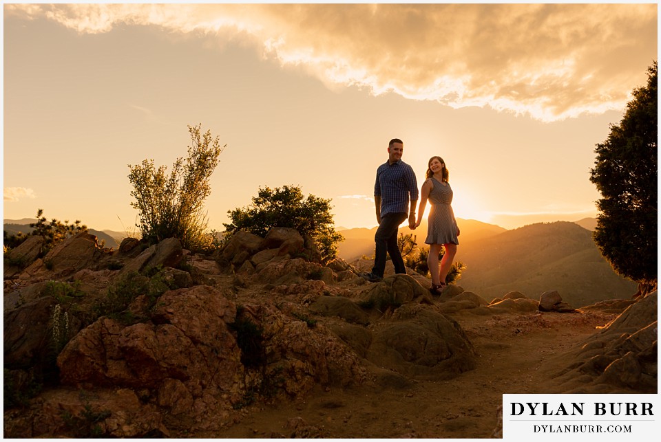 golden colorado mountain enagagement photo session couple playing in the sunset light