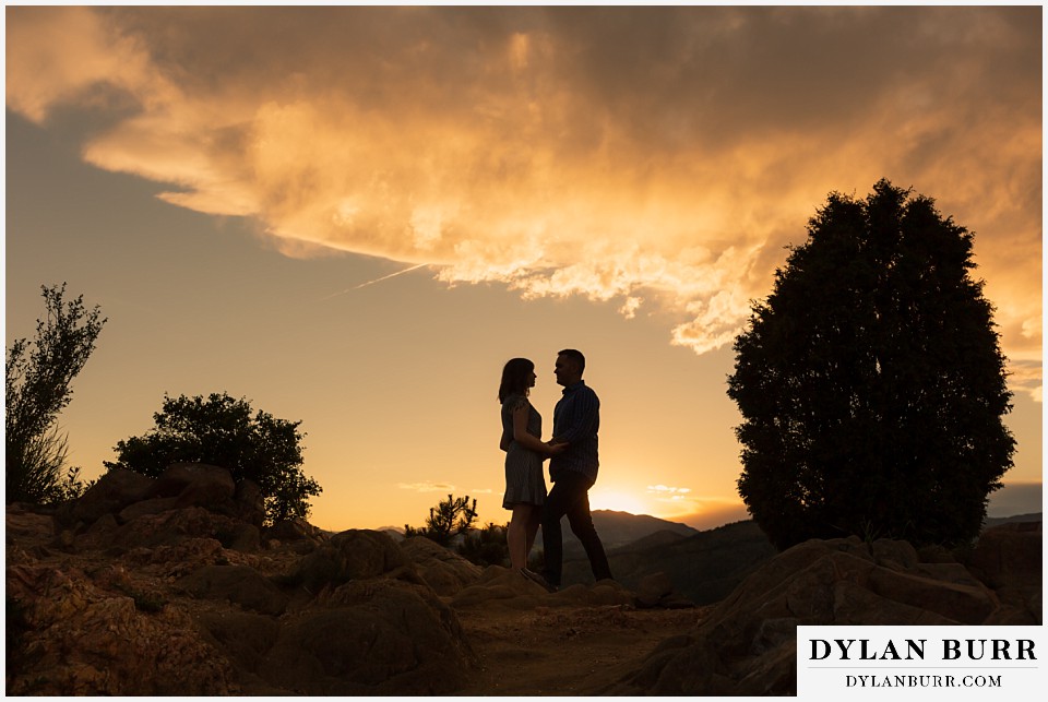 golden colorado mountain enagagement photo session couple with awesome sunset clouds