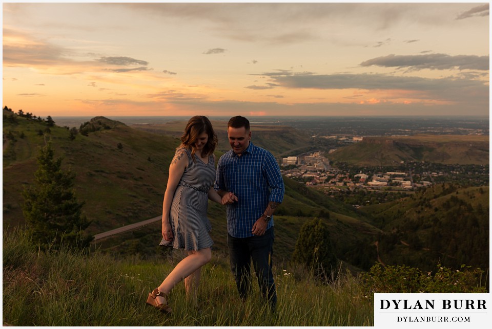 golden colorado mountain enagagement photo session couple hiking back up mountain together