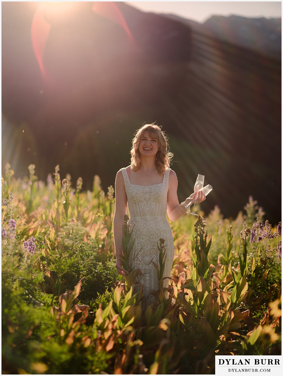 crested butte wedding elopement bride in wildflowers with champagne flutes