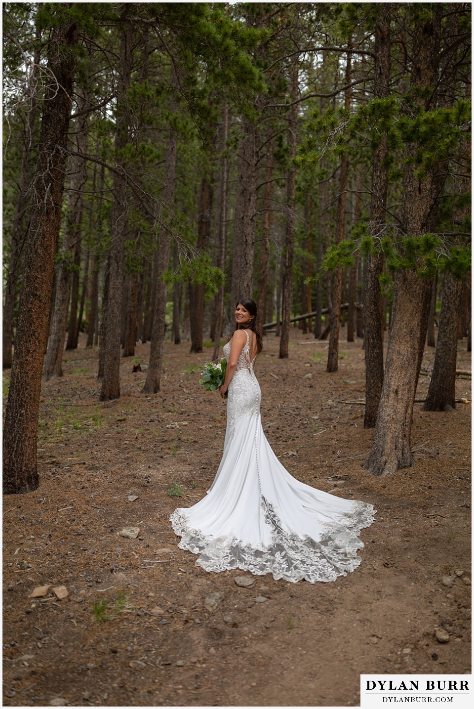 dao house wedding bride standing in pine trees showing off dress