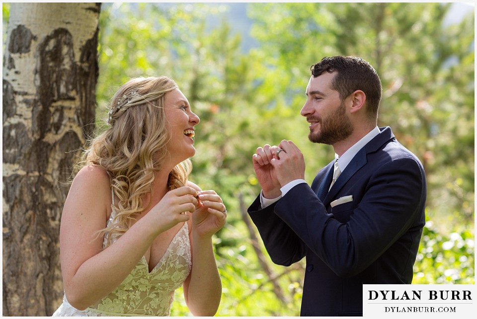 della terra mountain chateau wedding colorado rocky mountain national park wedding rmnp elopement bride and groom laughing together in forest