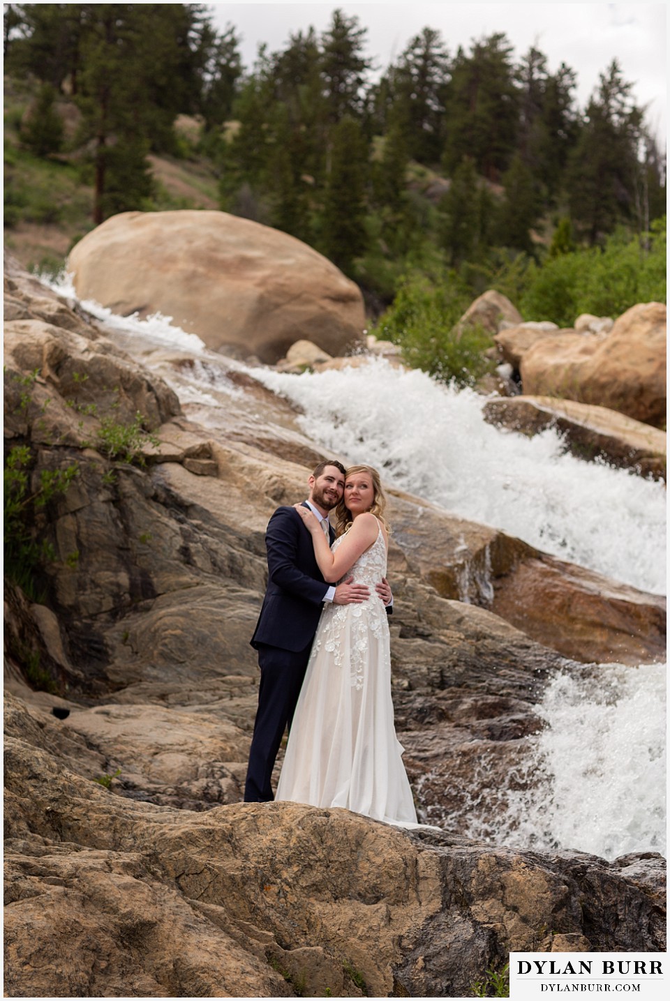 della terra mountain chateau wedding colorado rocky mountain national park wedding rmnp elopement bride and groom at large waterfall looking out into valley