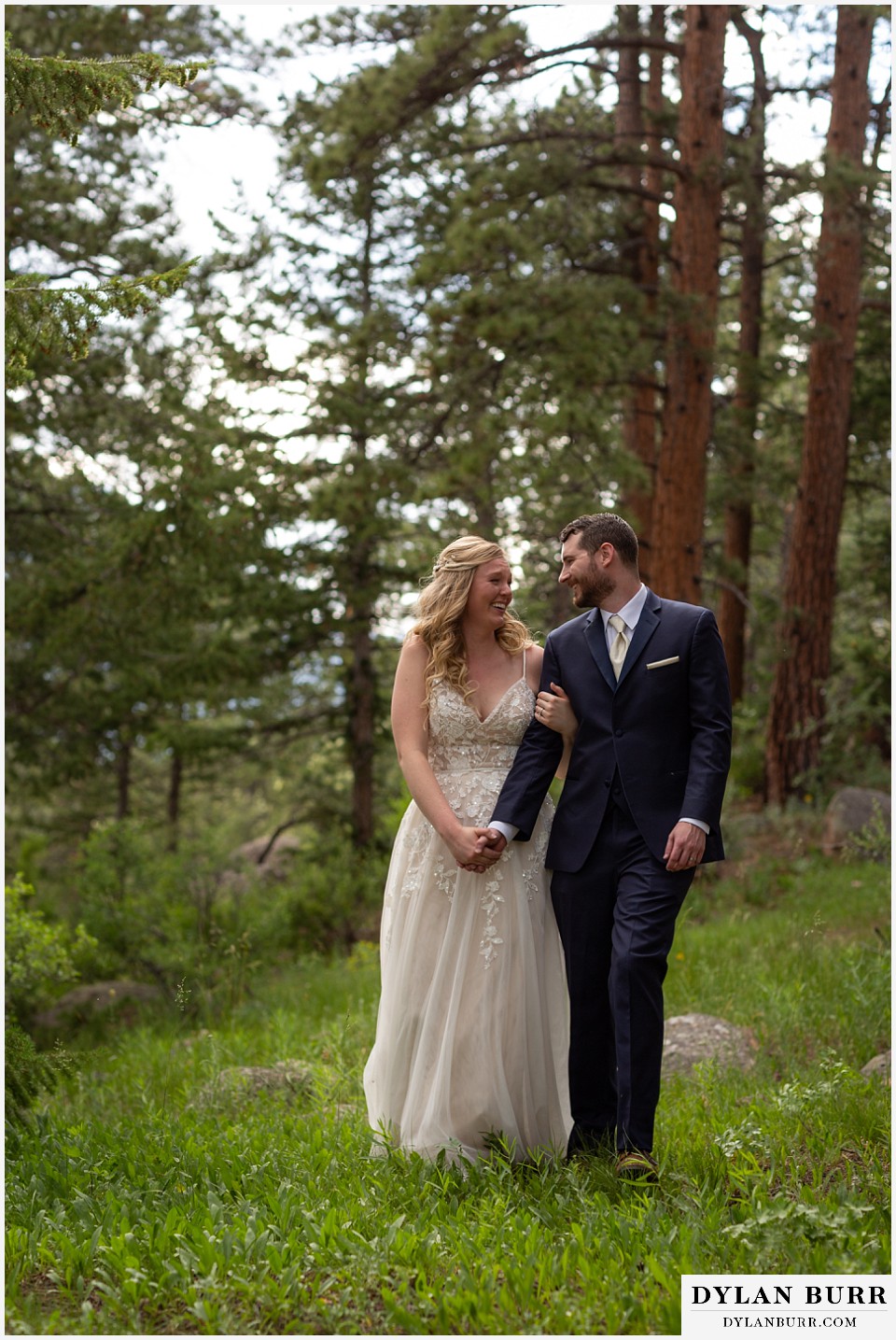 della terra mountain chateau wedding colorado rocky mountain national park wedding rmnp elopement bride and groom walking together and laughing