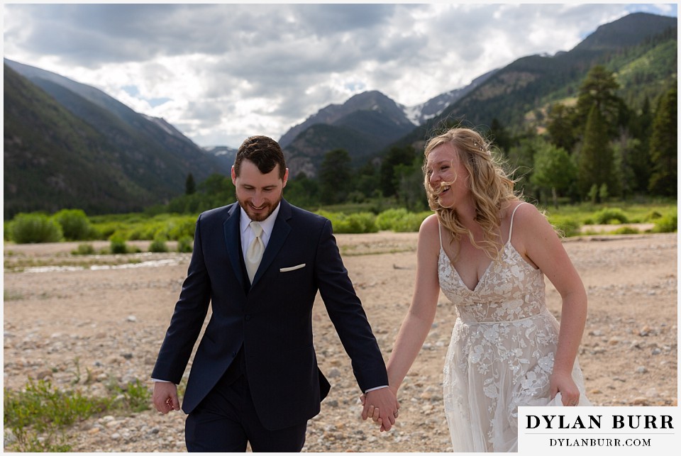 della terra mountain chateau wedding colorado rocky mountain national park wedding rmnp elopement bride and groom find each other and laugh while holding hands