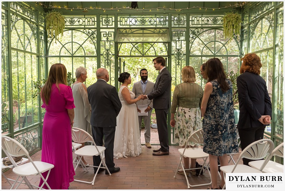 denver botanic gardens wedding colorado woodland mosaic bride groom holding hands saying vows during wedding ceremony