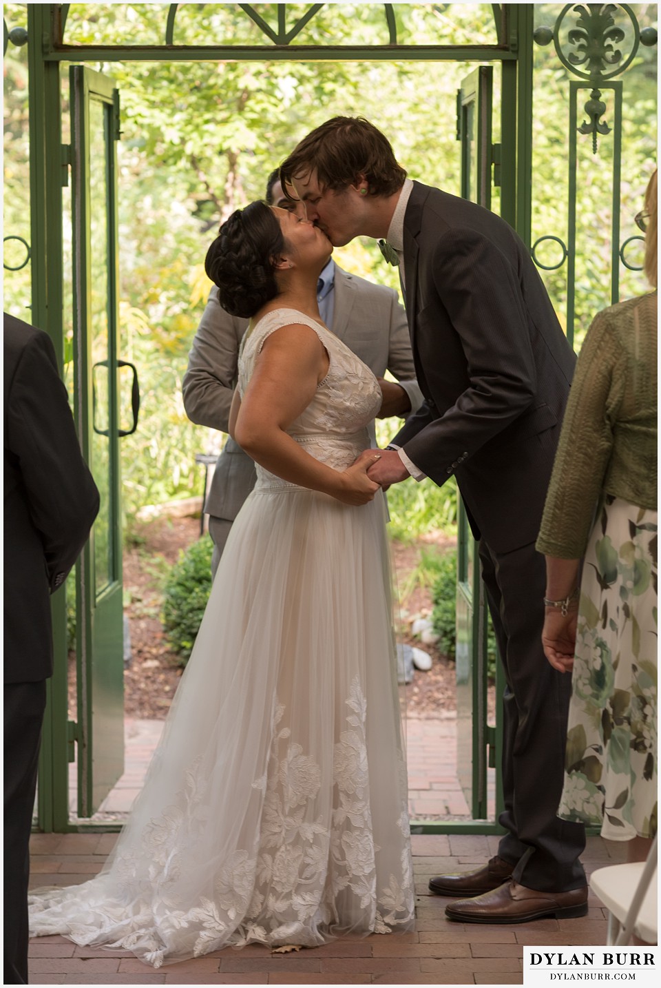 denver botanic gardens wedding colorado woodland mosaic bride groom first kiss during wedding ceremony