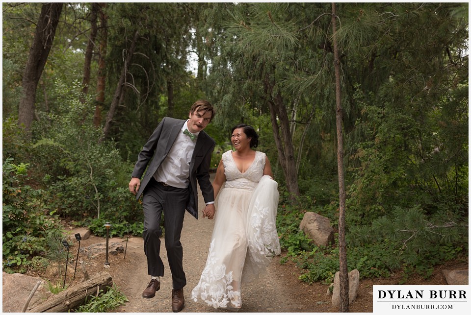 denver botanic gardens wedding colorado woodland mosaic bride groom skipping on path