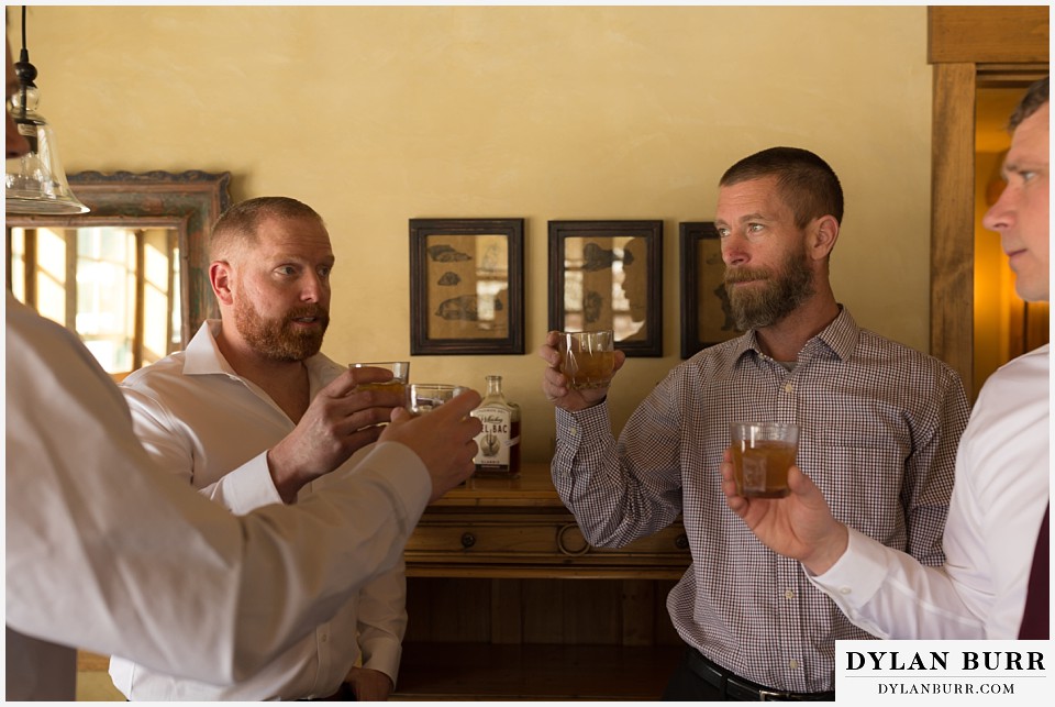 devils thumb ranch wedding in winter groomsmen whiskey toast