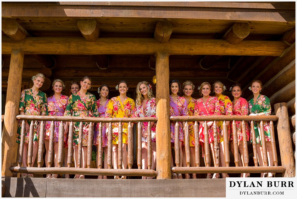 devils thumb ranch wedding bride and bridesmaids in flower print robes on cabin porch