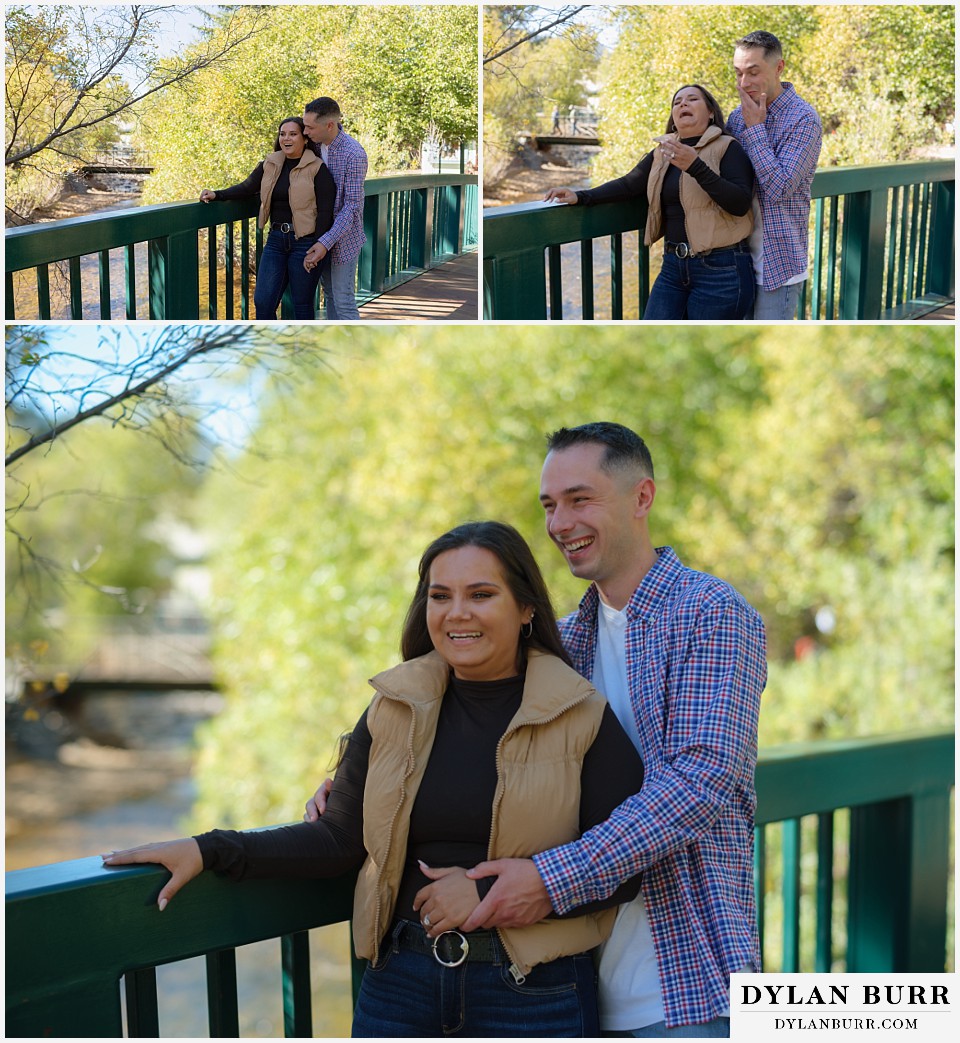 downtown estes park engagement photos couple laughing together on bridge over the river