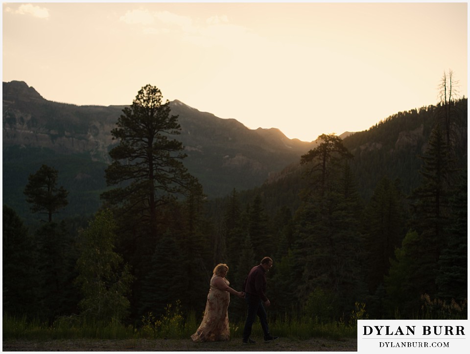 newlywed couple walking together at sunset in mountains in pagosa springs colorado