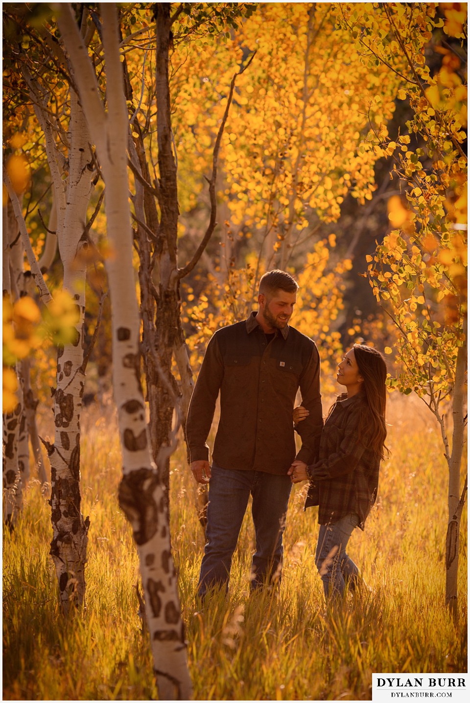 engagement photos golden colorado photographer couple walking together in the mountain during fall in colorado