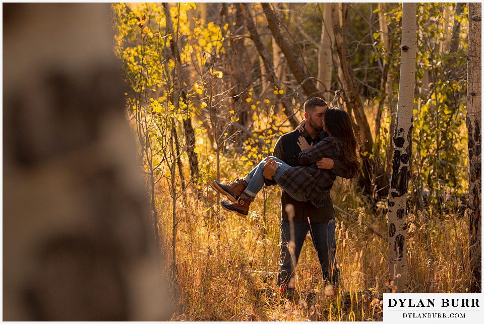 engagement photos golden colorado photographer couple holding her up in his arms