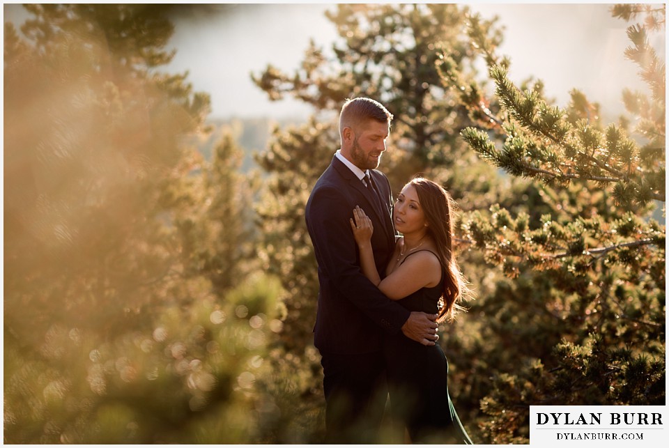 engagement photos golden colorado photographer couple standing together in pine trees