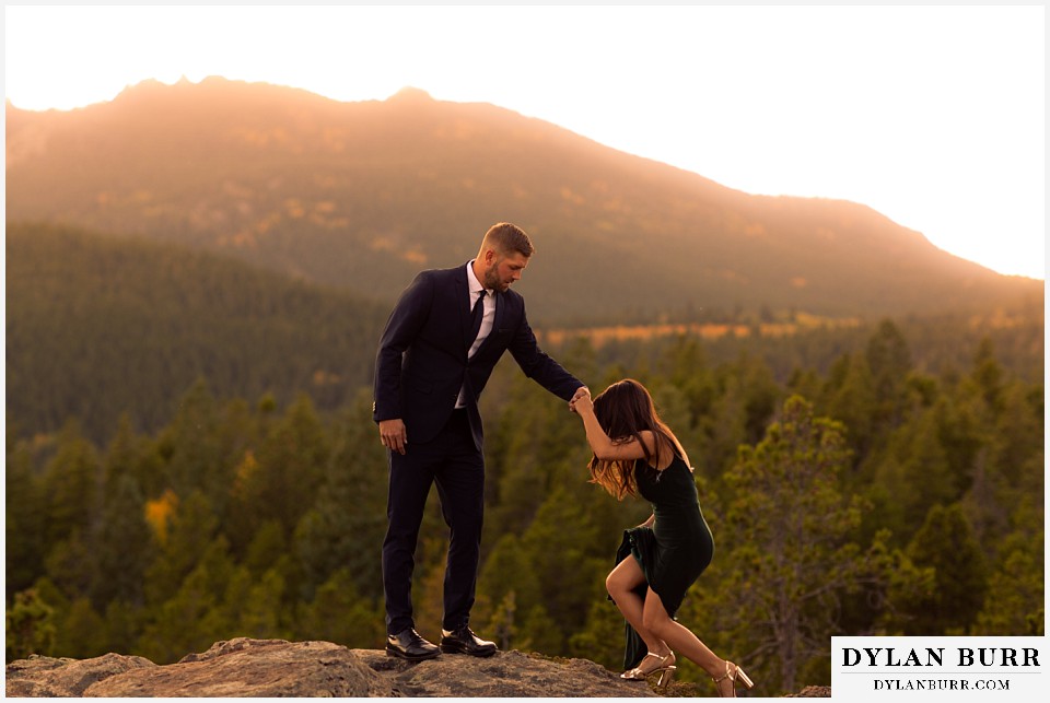 engagement photos golden colorado photographer couple climbing up rock