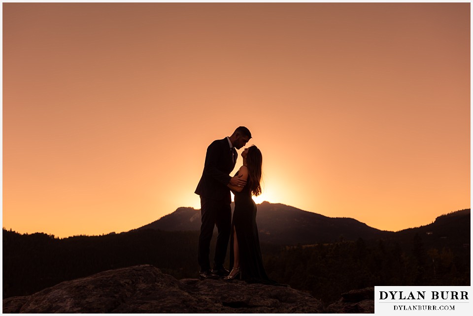 engagement photos golden colorado photographer couple standing on top of mountain at sunset