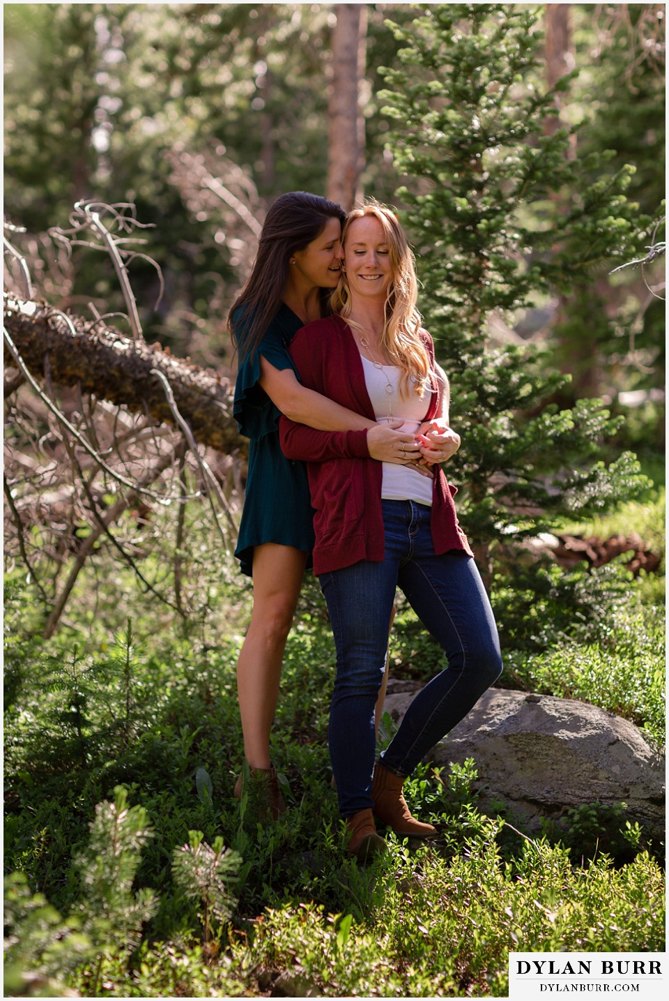 estes park engagement photos couple snuggling in close in the forest