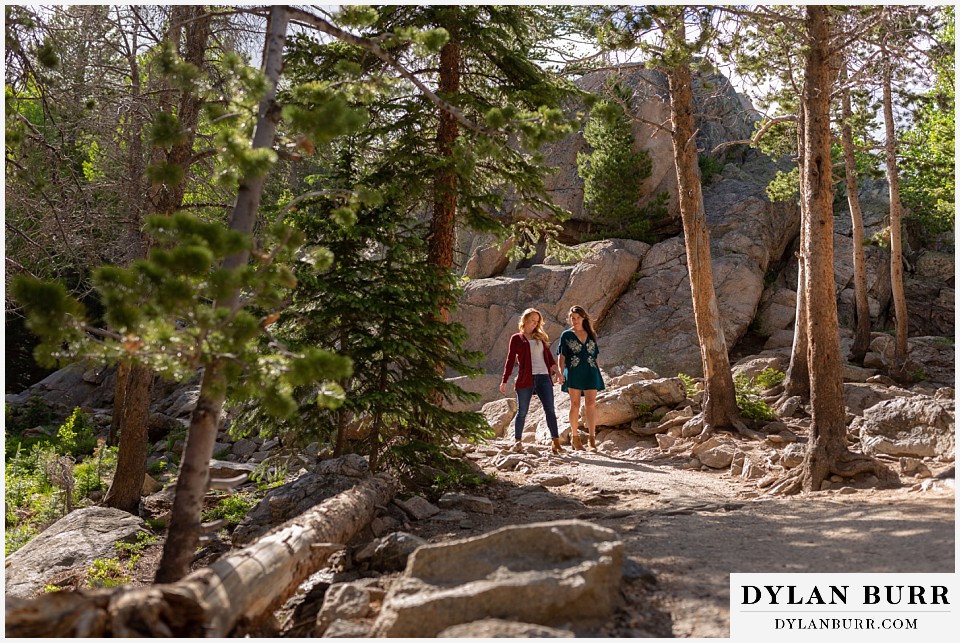 estes park engagement photos couple walking together down mountain trail
