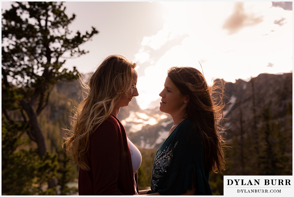 estes park engagement photos looking at each other with lots of love in mountains