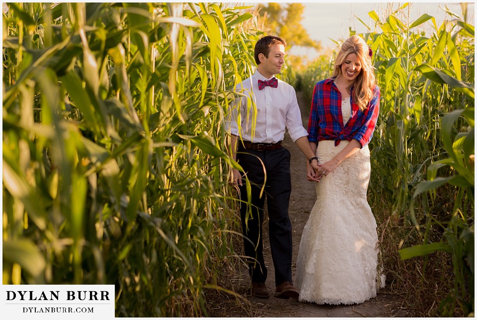 fall anniversary photos bride and groom walking together in corn maze