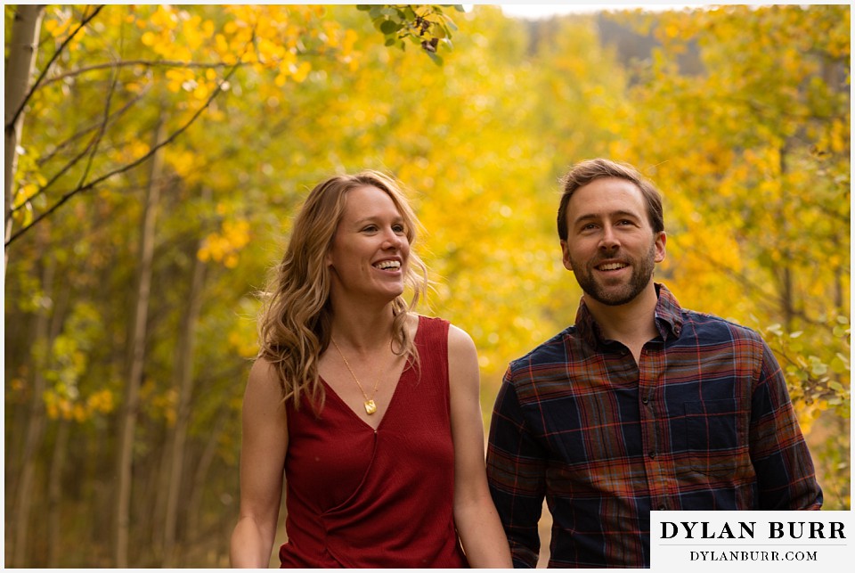 fall engagement photos in colorado yellow aspen trees happy couple