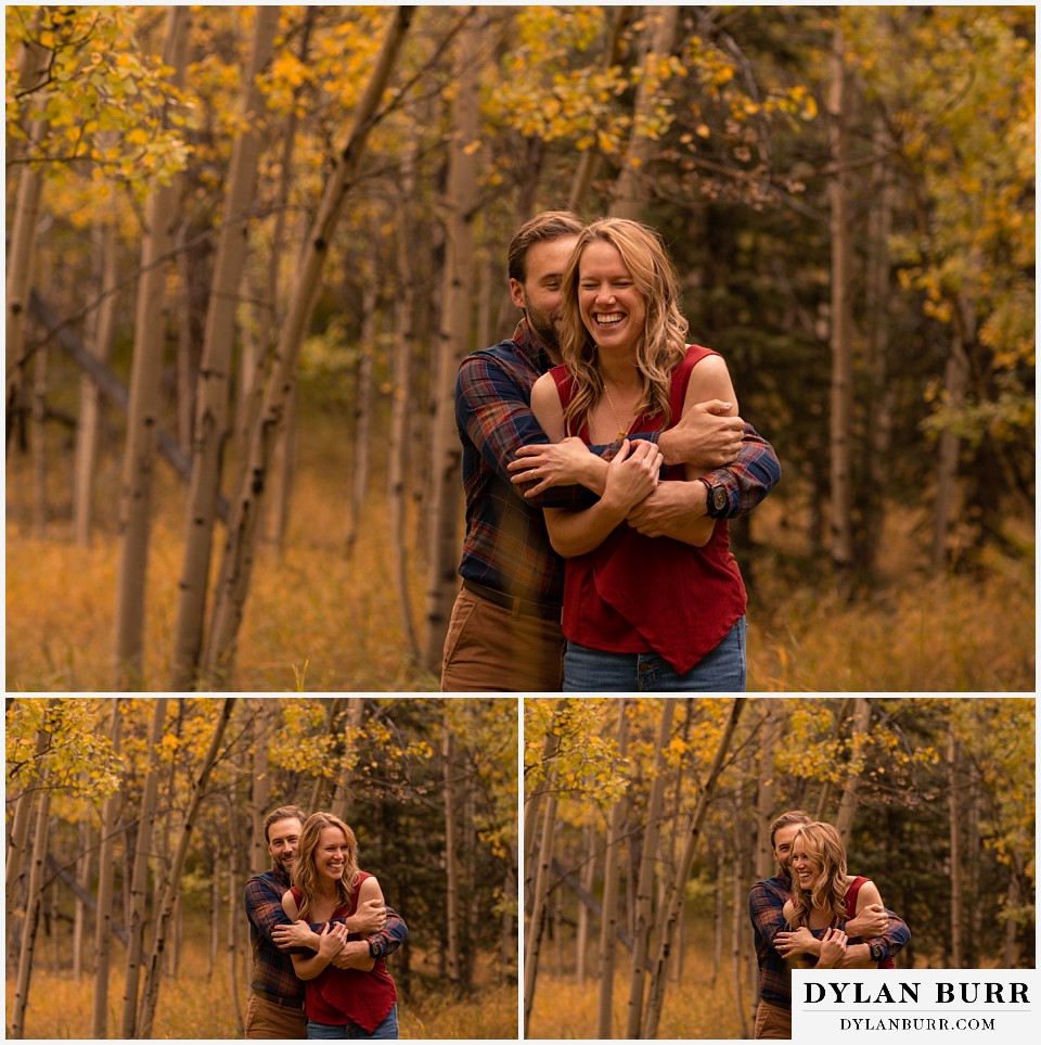 fall engagement photos in colorado groom hugging bride to be in aspen trees