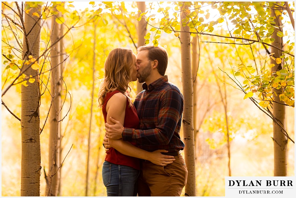fall engagement photos in colorado engaged couple kissing