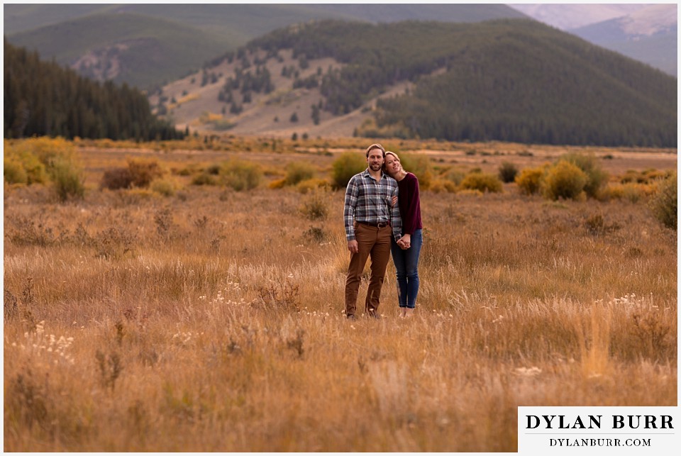 fall engagement photos in colorado couple in wide open field