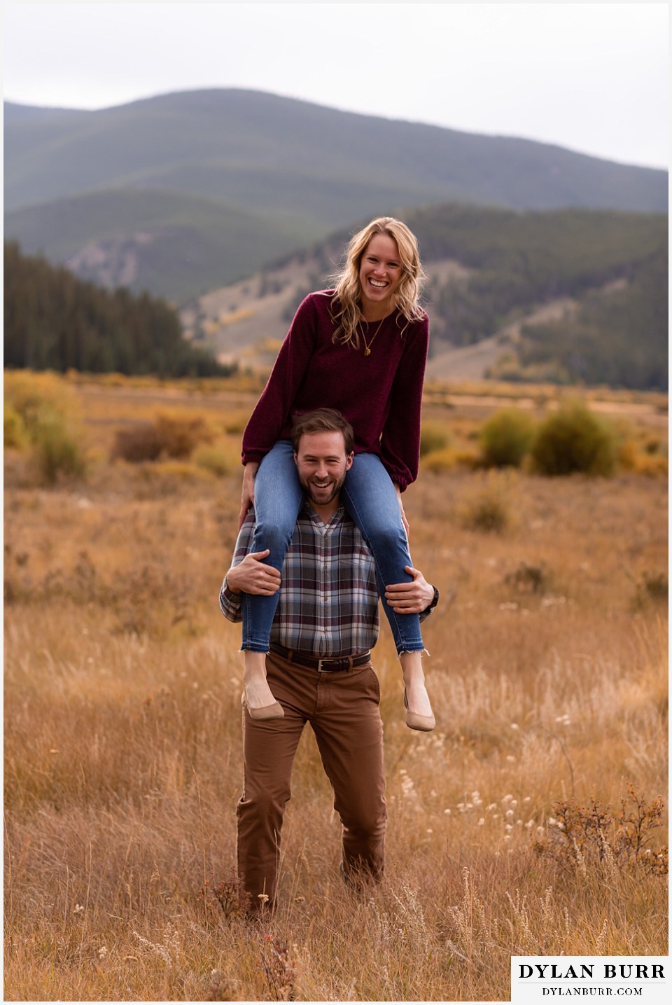fall engagement photos in colorado bride riding on top of grooms shoulders