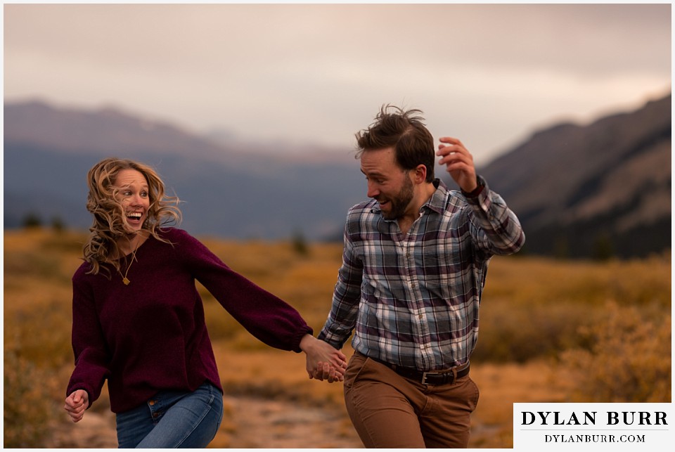 fall engagement photos in colorado couple looking at each other with huge smiles