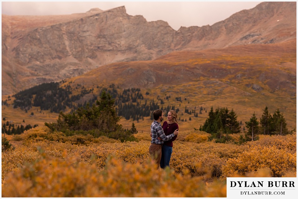 fall engagement photos in colorado huge mountain peaks in background